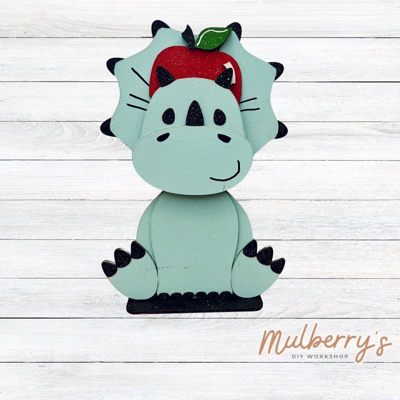 Our triceratops dinosaur is super cute! It's approximately 11.5" tall and can be paired with your favorite seasonal/holiday insert.
This set includes the interchangeable triceratops dinosaur and your choice of apple inserts:
-Headband with Bow Tie
-Apple
Please note that different inserts fit each type of dinosaur base differently. For our interchangeable triceratops, we recommended pairing it with the apple insert.