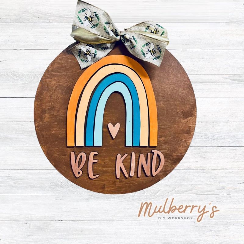 Show kindess with our 18" be kind rainbow door hanger!