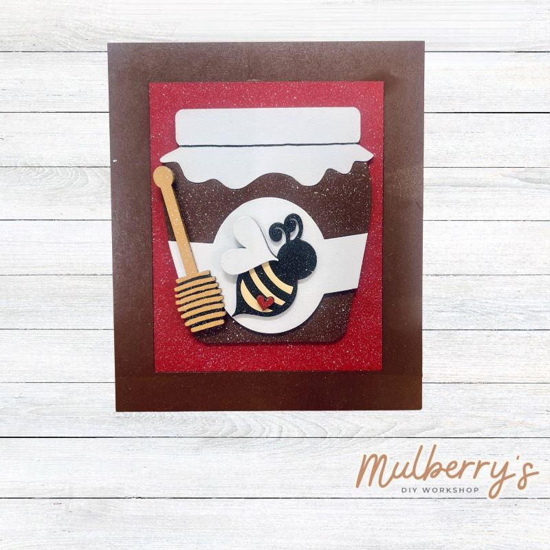 Our Interchangeable Rectangle Frame measures roughly 6.5" wide & 8" tall.
This project can easily be changed out for holidays, seasons and other themes. Because the frame leans back with the use of an easel, no magnets or adhesive hook and loop is needed.
The set includes the rectangle frame and honey jar insert.