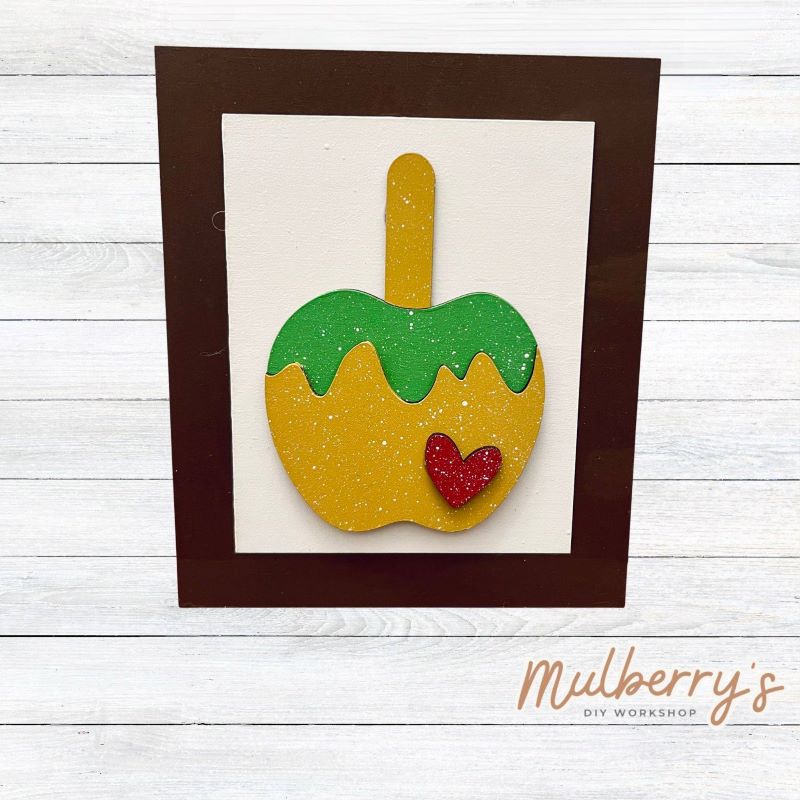 Our Interchangeable Rectangle Frame measures roughly 6.5" wide & 8" tall.
This project can easily be changed out for holidays, seasons and other themes. Because the frame leans back with the use of an easel, no magnets or adhesive hook and loop is needed.
The set includes the rectangle frame and candy apple insert.