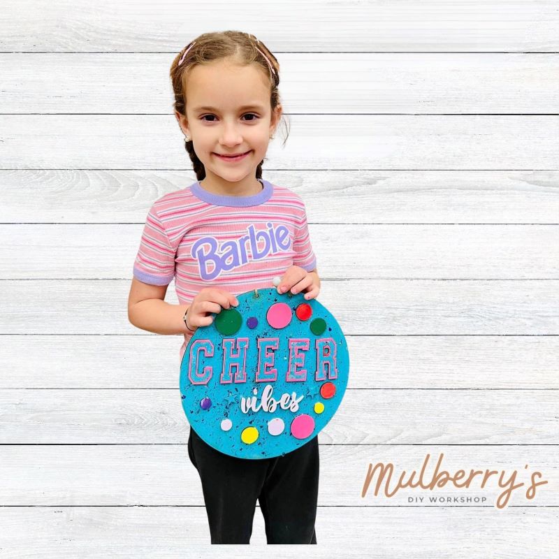 Get your little cheerleader her very own "Cheer Vibes" 9.5" mini door hanger!