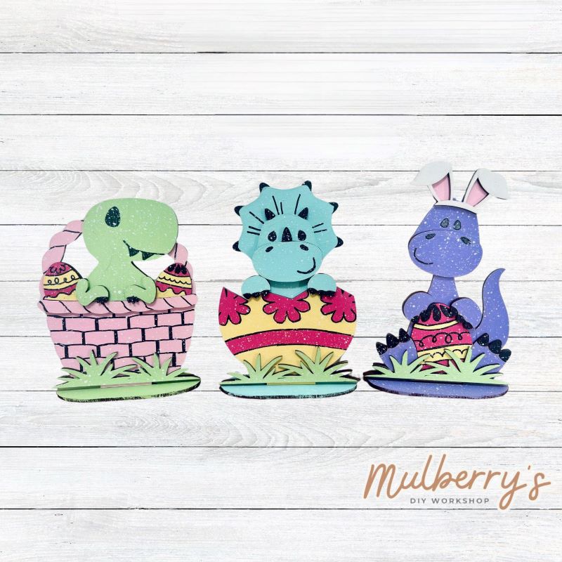 Our Easter dino mini shelf sitters are too cute! Approximately 6.5" tall. Each includes a stand.