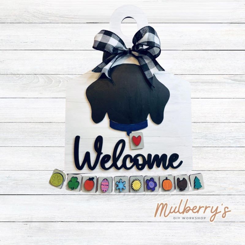 Our interchangeable dog is displayed on a cutting board backer and has 11 interchangeable pieces to swap on its collar. It's approximately 12-inches tall. Optional stand is available.