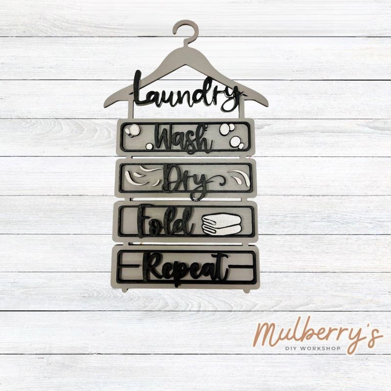 Wash, dry, fold, repeat! We have the perfect laundry hanger sign for you! It measures approximately 13" tall by 8" wide.