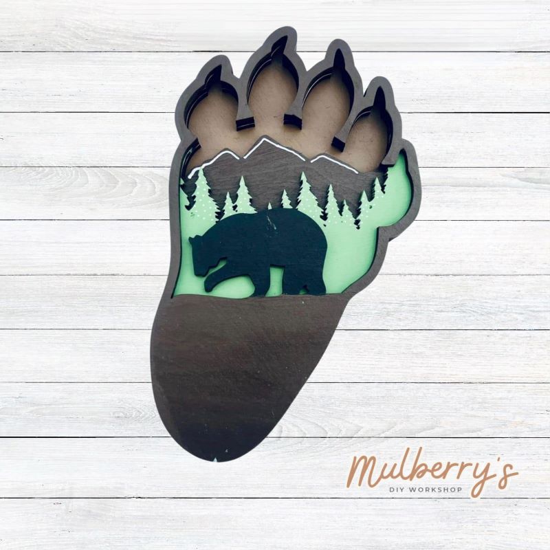 Our 4-layered bear paw is roughly 8.5 inches tall by 5" wide. It features mountains and a bear.