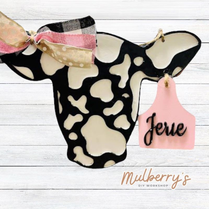 Does it get any cuter than this mini cow door hanger with personalized ear tag!? Measures roughly 14-inches tall.