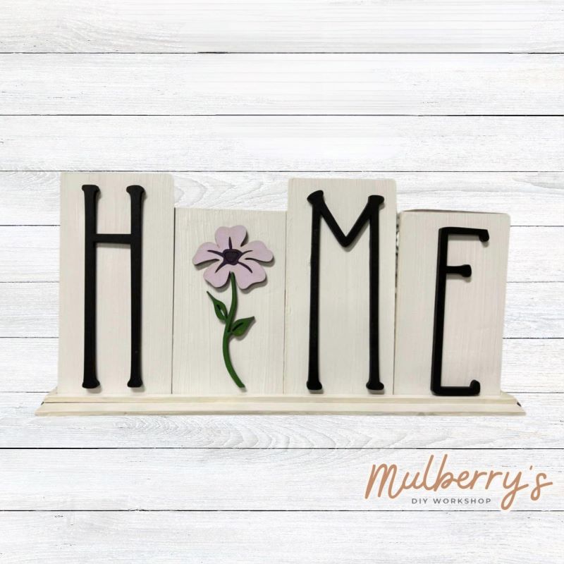 Looking for the perfect shelf sitter? Check out our interchangeable HOME shelf sitter! It's approximately 7" tall by 14" wide. Perfect for every holiday or season! This set includes the interchangeable HOME shelf sitter base and the flower insert. Additional inserts are available under Interchangeable Bases.