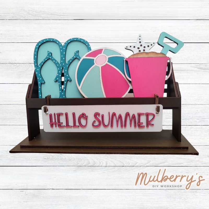 It doesn't get any cuter than our little rustic crate! It's a perfect add on accessory to your décor. It's approximately 13" long. Includes: Crate and Summer Inserts. Summer inserts include flip flops, beach ball, sand bucket, and the Hello Summer banner.