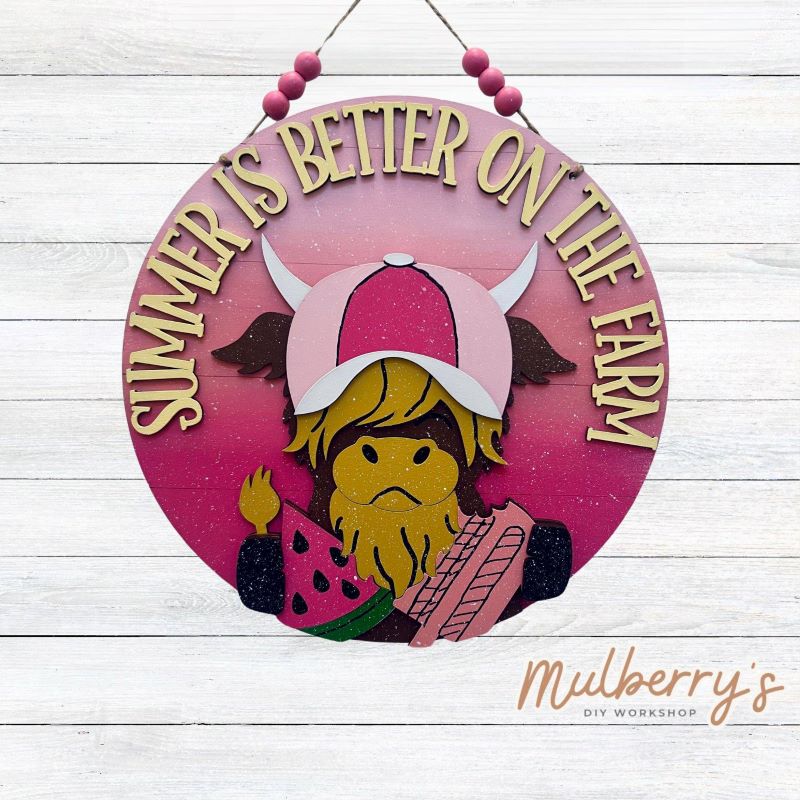 Our summer highland cow door hanger is sun-tastic! Approximately 10.5" in diameter and includes your choice of a mini bow or beads.