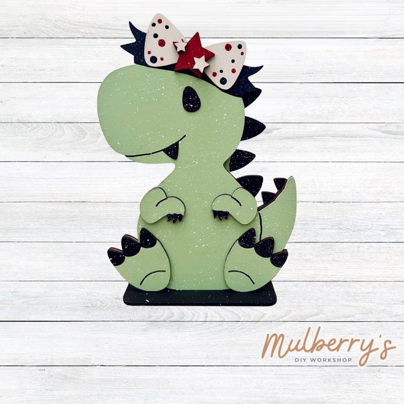 Our t-rex dinosaur is super cute! It's approximately 8" tall and can be paired with your favorite seasonal/holiday insert.
This set includes the interchangeable t-rex dinosaur and your choice of July 4th inserts:
-Headband with Bow Tie
-Headbow
-Statue of Liberty Spike Hat
Please note that different inserts fit each type of dinosaur base differently. For our interchangeable t-rex, we recommended pairing it with the headbow insert.
