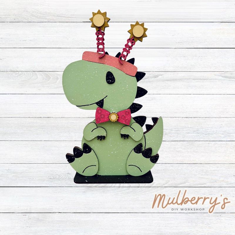 Our t-rex dinosaur is super cute! It's approximately 8" tall and can be paired with your favorite seasonal/holiday insert.
This set includes the interchangeable t-rex dinosaur and your choice of summer inserts:
-Headband with Bow Tie
-Headbow
-Tropical Flower Lei
Please note that different inserts fit each type of dinosaur base differently. For our interchangeable t-rex, we recommended pairing it with the headbow insert.