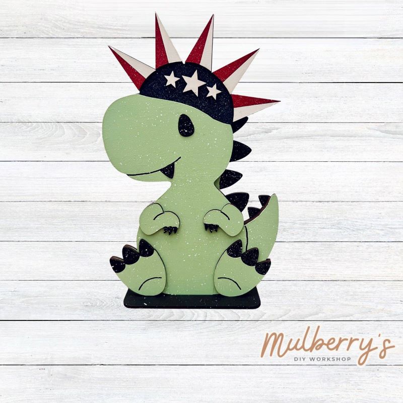 Our t-rex dinosaur is super cute! It's approximately 8" tall and can be paired with your favorite seasonal/holiday insert.
This set includes the interchangeable t-rex dinosaur and your choice of July 4th inserts:
-Headband with Bow Tie
-Headbow
-Statue of Liberty Spike Hat
Please note that different inserts fit each type of dinosaur base differently. For our interchangeable t-rex, we recommended pairing it with the headbow insert.