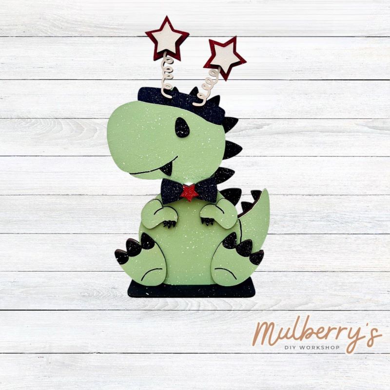 Our t-rex dinosaur is super cute! It's approximately 8" tall and can be paired with your favorite seasonal/holiday insert.
This set includes the interchangeable t-rex dinosaur and your choice of July 4th inserts:
-Headband with Bow Tie
-Headbow
-Statue of Liberty Spike Hat
Please note that different inserts fit each type of dinosaur base differently. For our interchangeable t-rex, we recommended pairing it with the headbow insert.