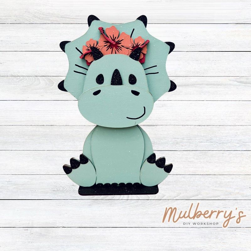 Our triceratops dinosaur is super cute! It's approximately 11.5" tall and can be paired with your favorite seasonal/holiday insert.
This set includes the interchangeable triceratops dinosaur and your choice of summer inserts:
-Headband with Bow Tie
-Headbow
-Tropical Flower Lei
Please note that different inserts fit each type of dinosaur base differently. For our interchangeable triceratops, we recommended pairing it with the tropical flower lei insert.
