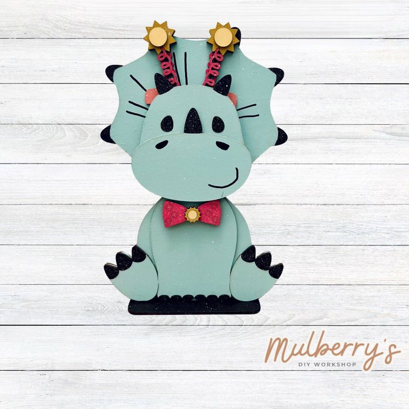Our triceratops dinosaur is super cute! It's approximately 11.5" tall and can be paired with your favorite seasonal/holiday insert.
This set includes the interchangeable triceratops dinosaur and your choice of summer inserts:
-Headband with Bow Tie
-Headbow
-Tropical Flower Lei
Please note that different inserts fit each type of dinosaur base differently. For our interchangeable triceratops, we recommended pairing it with the tropical flower lei insert.