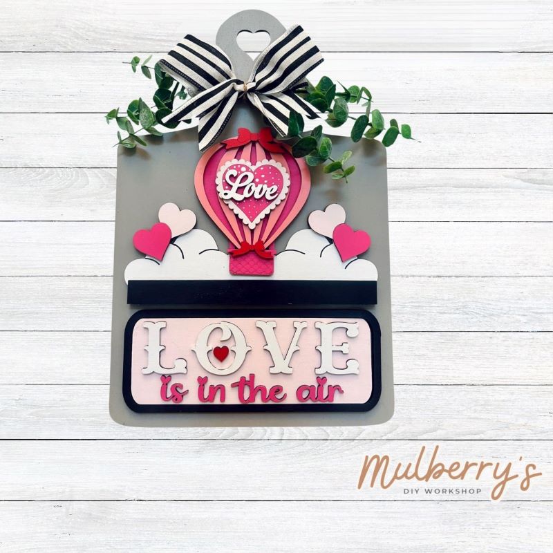 This Interchangeable Breadboard measures roughly 9" wide & 13.5" tall. This project can easily be changed out for holidays, seasons and other themes. Because the breadboard leans back with the use of an easel, no magnets or adhesive hook and loop is needed. The set includes the breadboard and valentine hot air ballon inserts.