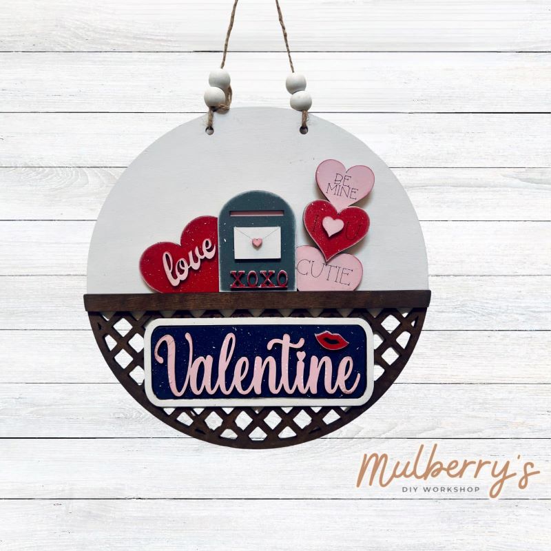 Welcome family and friends with our interchangeable lattice round door hanger! Simply swap out inserts to match the different holidays and seasons! It's approximately 10.5" in diameter. Includes: Lattice Round Door Hanger with Valentine Inserts. Additional inserts are available to purchase.