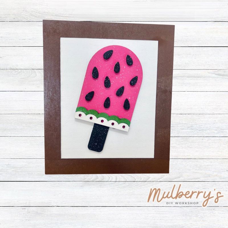 Our Interchangeable Rectangle Frame measures roughly 6.5" wide & 8" tall.
This project can easily be changed out for holidays, seasons and other themes. Because the frame leans back with the use of an easel, no magnets or adhesive hook and loop is needed.
The set includes the rectangle frame and watermelon popsicle insert.