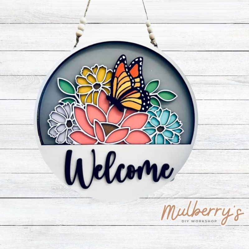 Welcome family and friends with our interchangeable welcome door hanger! Simply swap out inserts to match the different holidays and seasons! It's approximately 10.5" in diameter. Includes: Welcome Door Hanger with Butterfly Insert. Additional inserts are available to purchase.