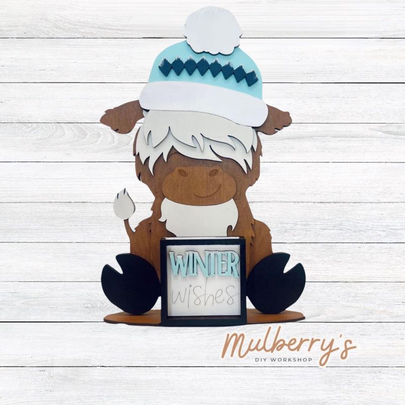 We love our interchangeable highland cow! It's approximately 9" tall and can be paired with your favorite seasonal/holiday insert. This set includes the interchangeable highland cow and the winter inserts.