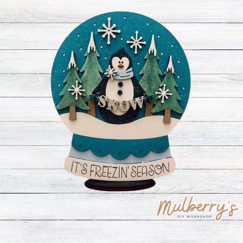 It's Freezin' Season! Celebrate the magical moments of winter with our winter penguin snowglobe shelf sitter! Approximately 11.5" tall by 9" wide. Includes a stand.