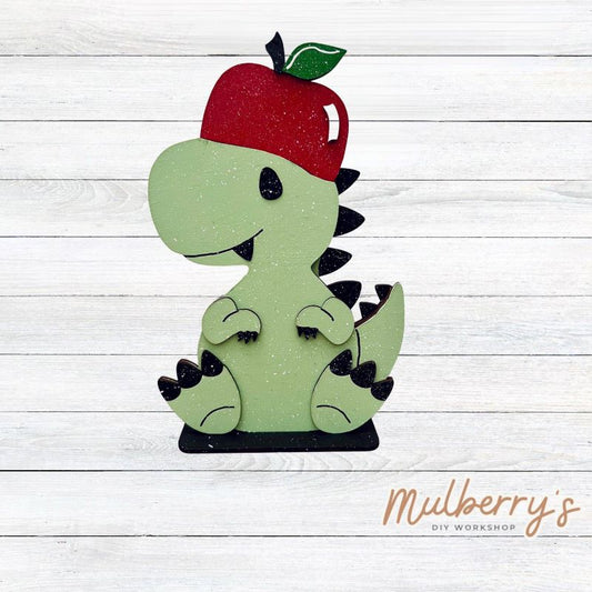 Our t-rex dinosaur is super cute! It's approximately 8" tall and can be paired with your favorite seasonal/holiday insert.

This set includes the interchangeable t-rex dinosaur and your choice of apple inserts:

-Headband with Bow Tie

-Apple

Please note that different inserts fit each type of dinosaur base differently.