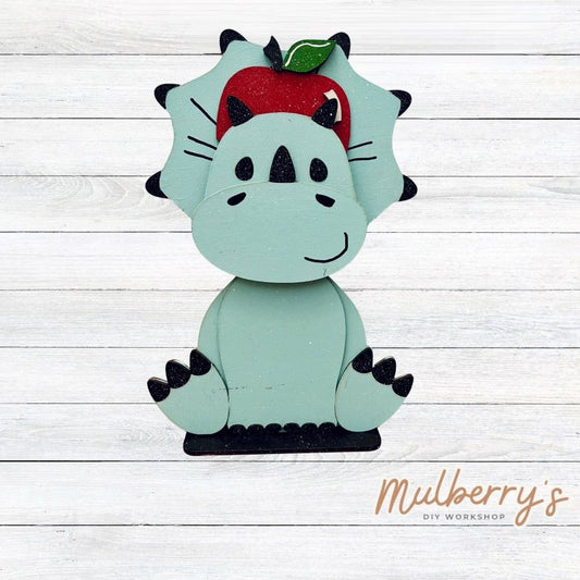 Our triceratops dinosaur is super cute! It's approximately 11.5" tall and can be paired with your favorite seasonal/holiday insert.

This set includes the interchangeable triceratops dinosaur and your choice of apple inserts:

-Headband with Bow Tie

-Apple

Please note that different inserts fit each type of dinosaur base differently. For our interchangeable triceratops, we recommended pairing it with the apple insert.