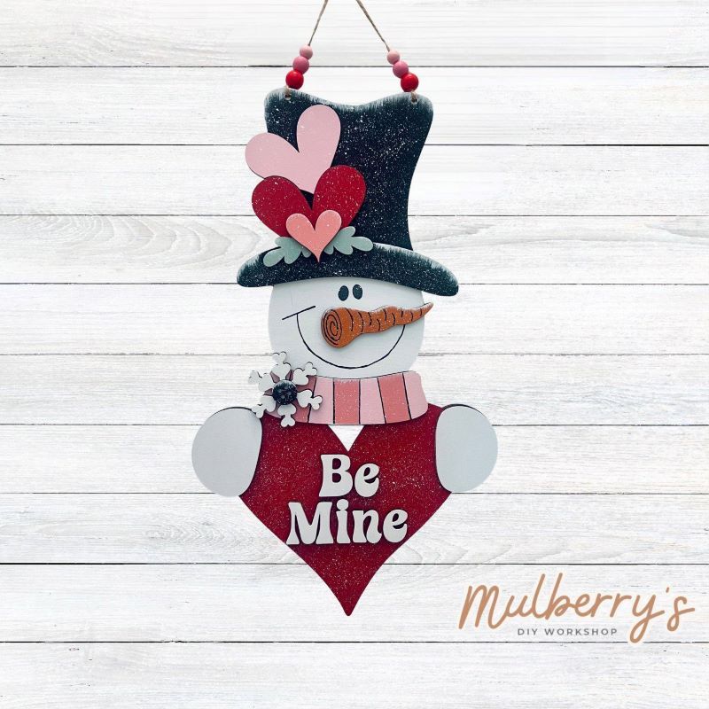 Surprise your valentine with our "Be Mine" snowman mini hanger! Approximately 18" tall. Includes your choice of either beads or a bow.