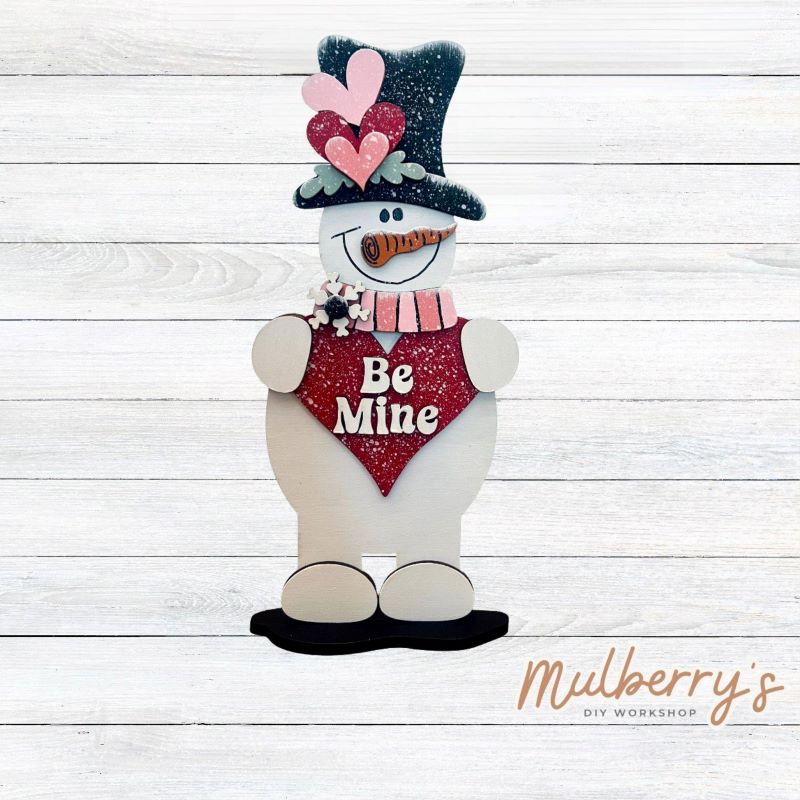 Brighten your winter days with our "Be Mine" snowman shelf sitter. Approximately 11" tall. Includes a stand.