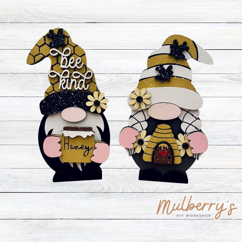 Our interchangeable mini gnomes are approximately 9" tall. They are 3 layers; therefore, they will stand freely.

There are two choices:

1. Gnome with beard

2. Gnome with braids

Hats and Hands are interchangeable and can be switched out for every holiday/season. Scrapbook paper embellishment is NOT included.

Includes interchangeable gnomes and bee inserts.
