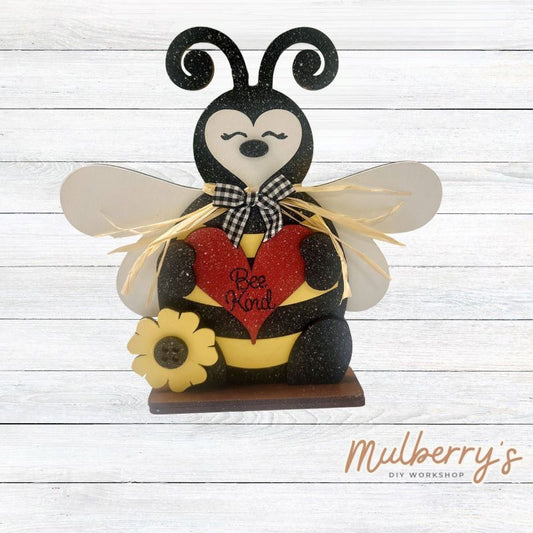 Bee kind with our stand-up bee shelf sitter! He's super cute with all the buzz and charm at approximately 7.5" tall! Includes stand.