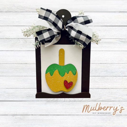 Our Interchangeable Mini Breadboard measures roughly 6.5" wide & 10.5" tall.

This project can easily be changed out for holidays, seasons and other themes. Because the breadboard leans back with the use of an easel, no magnets or adhesive hook and loop is needed.

The set includes the mini breadboard and candy apple insert.