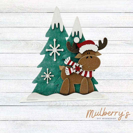 Need a new Christmas seasonal piece to spice up your decor? Look no further! Our new Christmas reindeer stand-up shelf sitter is here and ready for you to paint! This adorable fella measures approximately 7" wide by 11" tall. Includes a stand.