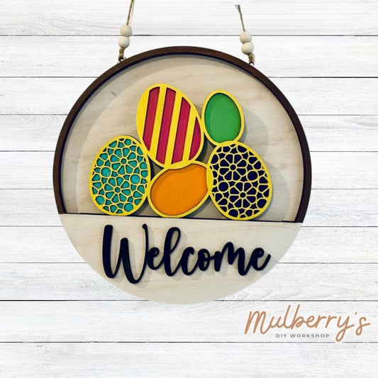 Welcome family and friends with our interchangeable welcome door hanger! Simply swap out inserts to match the different holidays and seasons! It's approximately 10.5" in diameter.  Includes: Welcome Door Hanger with Easter Eggs Insert. Additional inserts are available to purchase.