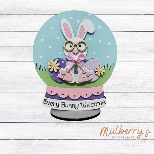 "Every Bunny Welcome" with this Easter bunny snowglobe shelf sitter! Approximately 8" tall. Includes stand.