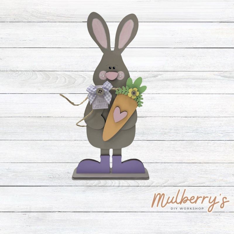 Hop into spring with our Easter bunny stand-up shelf sitter! Approximately 11" tall. Includes a stand.