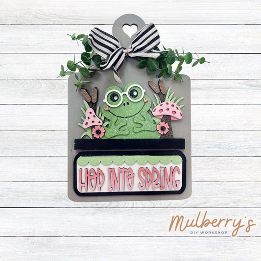 This Interchangeable Breadboard measures roughly 9" wide & 13.5" tall. 

This project can easily be changed out for holidays, seasons and other themes. Because the breadboard leans back with the use of an easel, no magnets or adhesive hook and loop is needed.

The set includes the breadboard and frog inserts.