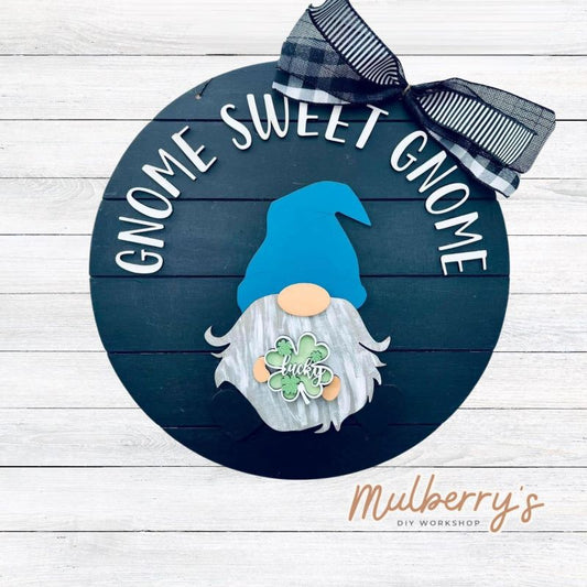 This sweet little fella will make you smile each season and holiday. Simply swap out his hands to create a brand new door hanger! The door hanger is approximately 18-inches in diameter and comes with or without greenery on the backer. Includes Gnome Sweet Gnome door hanger with st. patty insert.