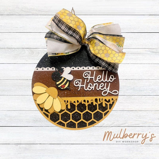 Hello Honey! Our newest bee hanger is honey-rrific! It's approximately 10.5" in diameter and includes your choice of beads or a bow.