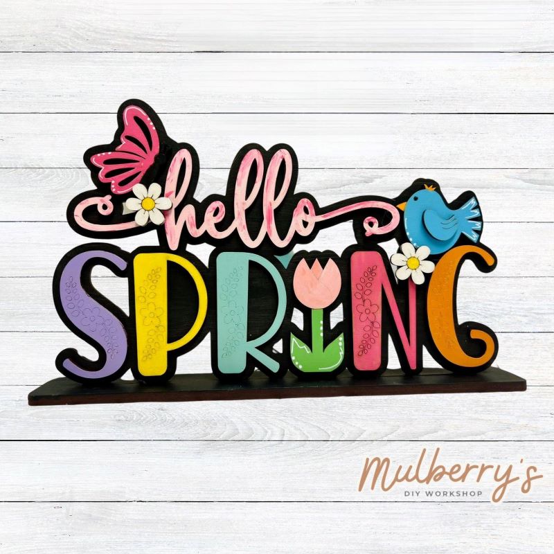 Our Hello Spring shelf sitter is the perfect addition to your spring decor! Approximately 9" wide by 6" tall. Includes stand.