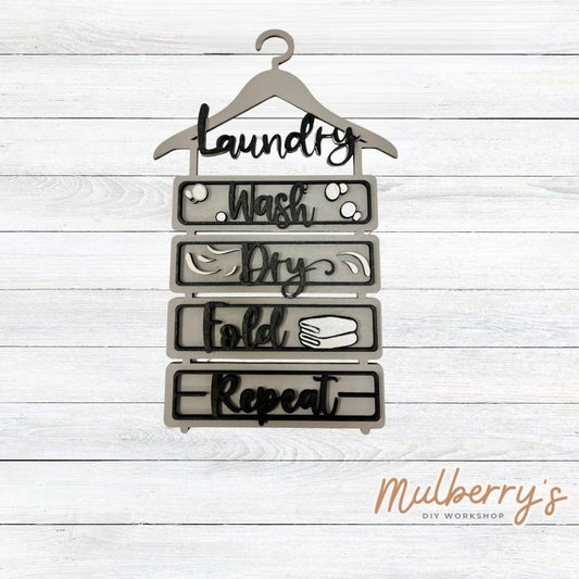 Wash, dry, fold, repeat! We have the perfect laundry hanger sign for you! It measures approximately 13" tall by 8" wide.