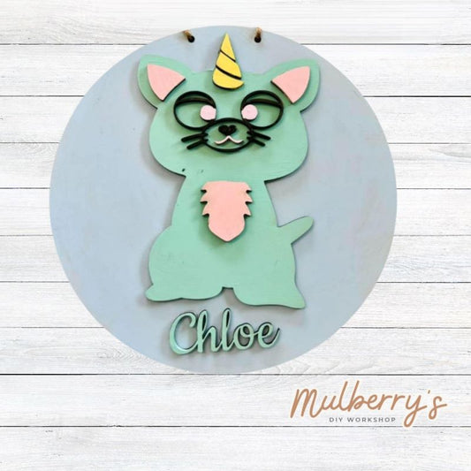 Our mini 9.5" door hanger with a caticorn and is a popular project for kids! This design can be personalized with a name in either print or cursive.