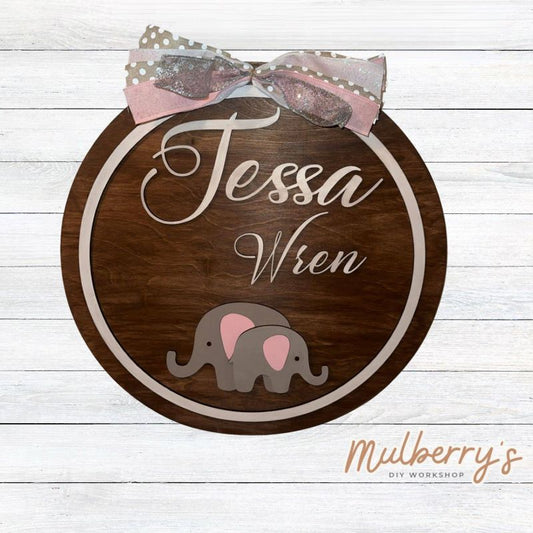 Celebrate the birth of your little one with our 18" personalized elephant nursery door hanger!