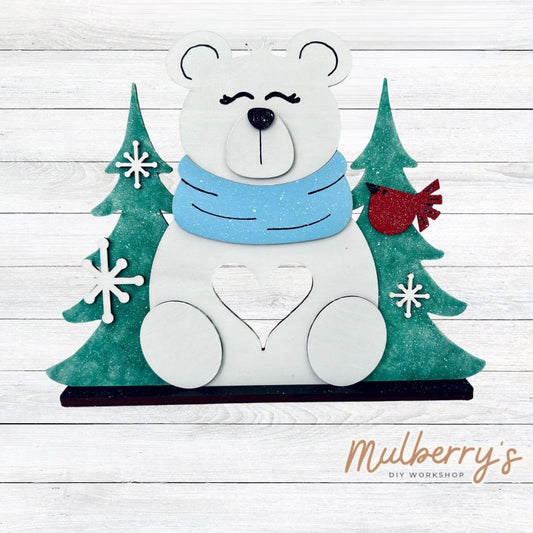 Brighten your winter days with our charming polar bear shelf sitter-designed with a perfect nook for a soft, flickering tea light. Approximately 9" tall by 11.5" wide. Includes stand base.

Please note that a physical tea light is NOT provided with this project.