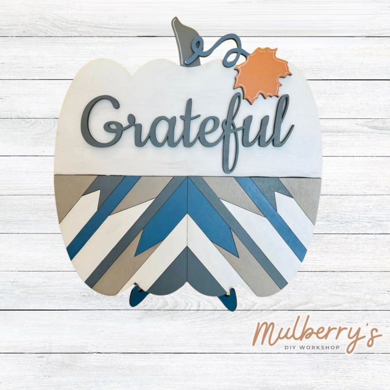 Our barn quilt pumpkin is perfect for fall! Approximately 10.5" tall by 10.5" wide. Optional stand is available.  Words to choose from: Blessed, Gather, Grateful, and Thankful.