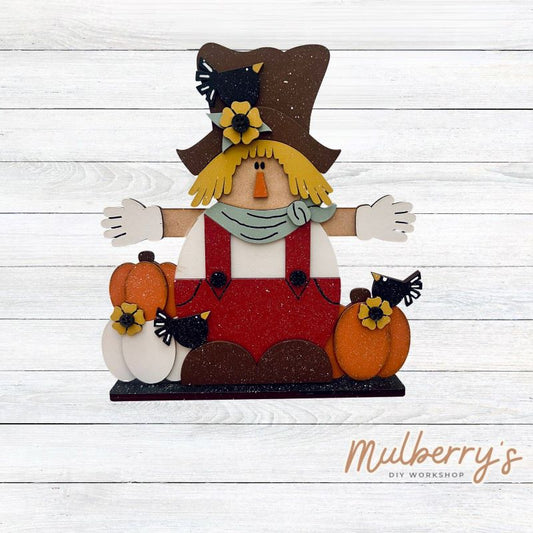 Crows, beware! Our adorable scarecrow stand-up shelf sitter is the perfect look-out! He's approximately 10.5" tall by 9" wide and includes a stand.