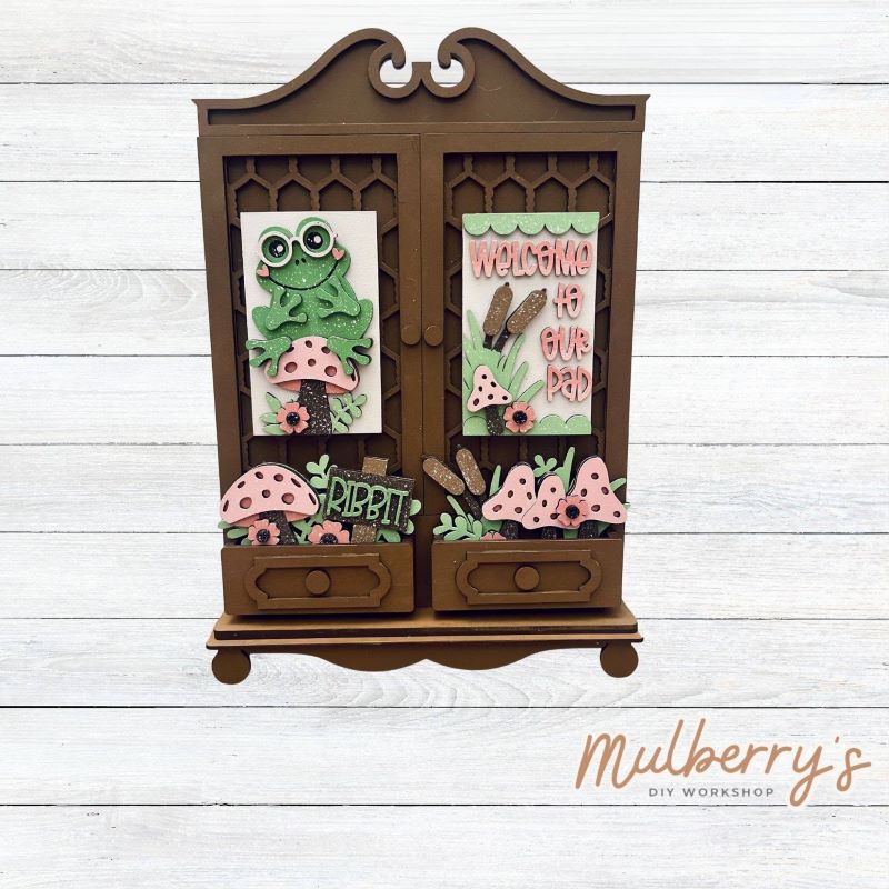 It doesn't get any cuter than our new double cottage mega shelf sitter! It's the perfect add-on accessory to your decor at approximately 16" tall by 11" wide.

Includes: Double Cottage and Spring Frog Inserts pictured.