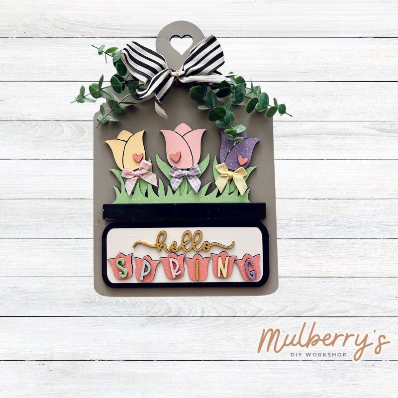 This Interchangeable Breadboard measures roughly 9" wide &13.5" tall.

This project can easily be changed out for holidays, seasons and other themes. Because the breadboard leans back with the use of an easel, no magnets or adhesive hook and loop is needed.

The set includes the breadboard and spring flowers inserts.