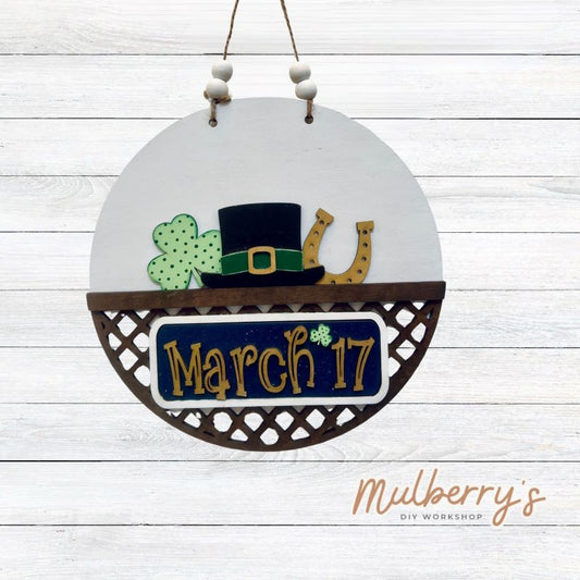 Welcome family and friends with our interchangeable lattice round door hanger! Simply swap out inserts to match the different holidays and seasons! It's approximately 10.5" in diameter.  Includes: Lattice Round Door Hanger with St. Patty Inserts. Additional inserts are available to purchase.