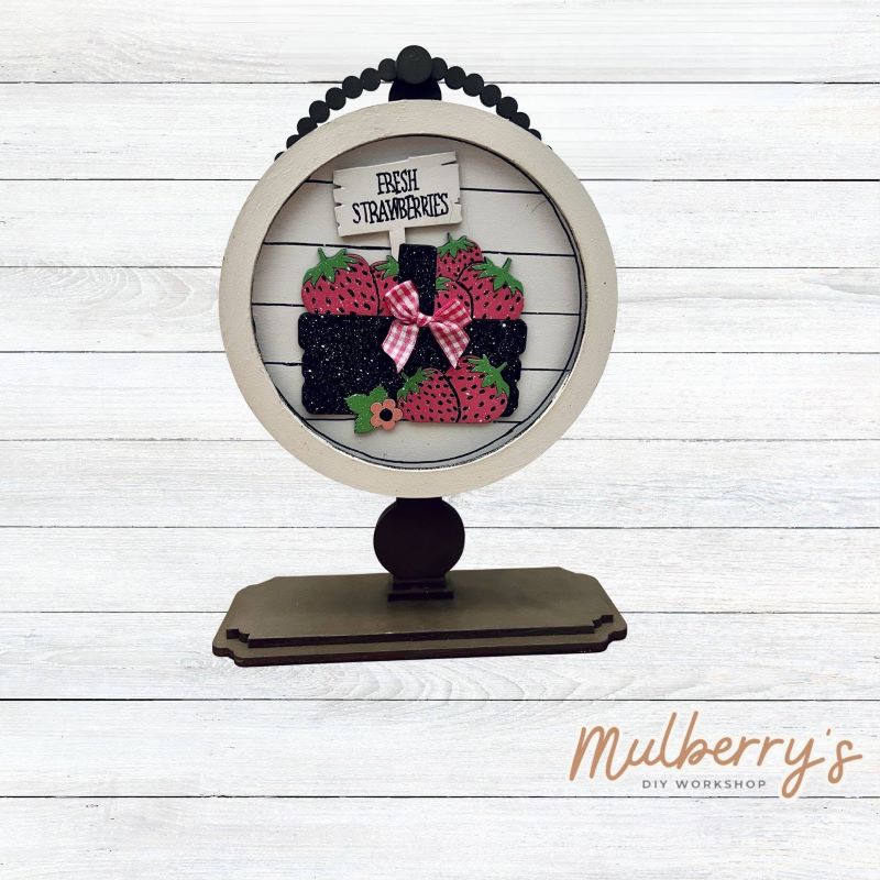 We love our interchangeable tabletop! It's approximately 10" tall and can display your favorite seasonal/holiday insert.

This set includes the interchangeable tabletop and the fresh strawberries insert.